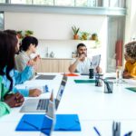 Multiracial employees listen to indian boss in company meeting. Copy space.