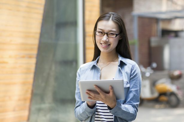 Young woman holding a digital tablet